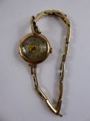 A Lady's 9 ct (375) Cocktail Watch, engine turned face on rolled gold bracelet, 13714 stamp, in