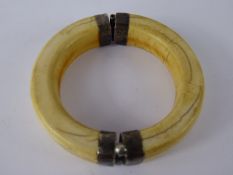 An Antique Warthog Tusk and Silver Metal Arm Bracelet. (af)