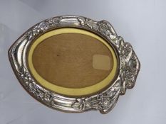A Silver Art Nouveau Oval Picture Frame, with an oak easel back, Birmingham hallmark, dated 1904,