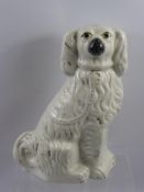 A Staffordshire Fireside Spaniel, together with two further Spaniels graduated in size.