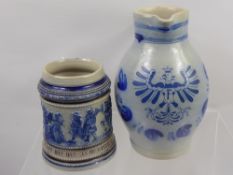 A German Westerwald Stoneware Ale Jug, decorated with a Coat of Arms, together with a Westerwald