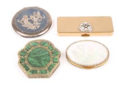 An Eastern silver compact with engraved decorationtogether with three other compacts. (4),