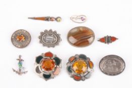A collection of Victorian and later silver brooches including four Scottish agate brooches, an