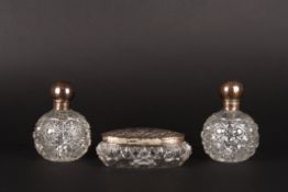 A pair of silver mounted cut glass dressing table bottlestogether with a matched silver topped oval