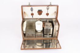 A vintage travelling picnic set for twothe rectangular fitted leather case opening up to reveal two