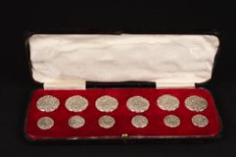 A set of late Victorian embossed silver buttonshallmarked Birmingham 1901, decorated with a scene