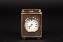 A George V miniature silver carriage clockhallmarked London 1912, the case with engine turned