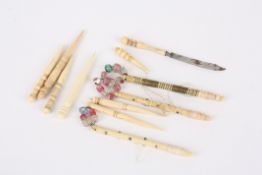 A collection of sewing accessoriescomprising six hcuttles and five thread winders (some bone and