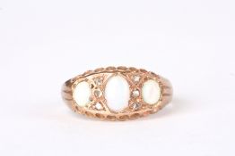 A 9ct gold and opal three stone ringset with three oval opals interspersed by six small diamonds in