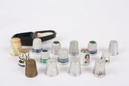 A cased Royal Worcester thimbleof blush ivory colour with studded blue turquoise decoration,