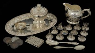 An Indonesian .800 standard silver milk jug and sugar bowl on oval tray set embossed with flowers,