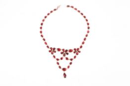 A Georgian flat cut garnet floral garland drop necklace, the chain linked garnets foil backed and