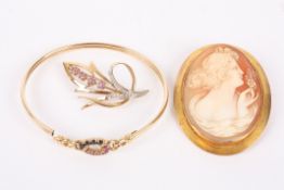 A contemporary 9ct gold and sapphire set bangle, a similar ruby and diamond point foliate brooch and