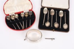 A set of six Art deco silver coffee spoons, cased, another set of silver spoons, a silver scroll
