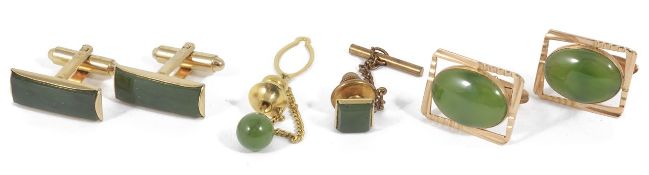 A pair of green hardstone mounted cufflinks, in yellow metal rectangular mounts, stamped 18K,