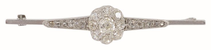 A late Victorian/Edwardian diamond set cluster brooch having a central old cut diamond cluster