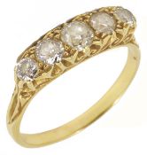 A five stone diamond set half hoop ring with pierced scroll gallery mount, marked 18ct. Size