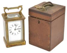 A 19th century brass striking carriage clock with white enamel dial and black Roman numerals,
