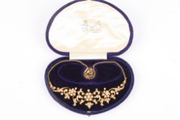 A good Edwardian diamond and pearl necklace of scrolling floral design having central diamond and