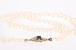 A single row graduated cultured pearl necklace of slight pinkish hue, with fancy yellow metal