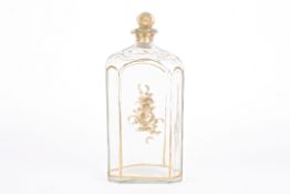 A large early 19th century gilt decorated glass decanter and stopper of rectangular form with canted