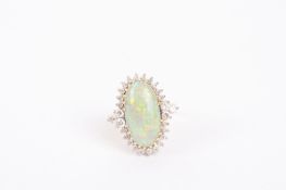 A large contemporary oval opal and diamond set fancy ring the opal measuring approx. 2 cm top to