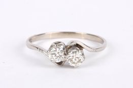 An 18ct white gold mounted two stone diamond cross over ring stones approx. 0.23ct each Size S/