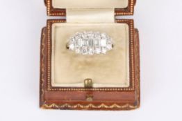 An Art deco style diamond set cocktail ring having five central graduating rectangular cut