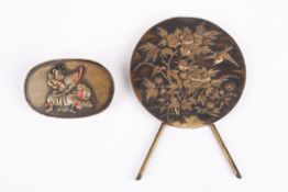 A small Japanese circular bronze plaque decorated in relief with birds and flowers, with easel