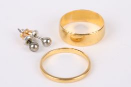 A wide hallmarked 22ct gold wedding band sold together with a narrow hallmarked 22ct gold wedding