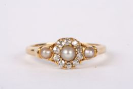 A delicate Victorian pearl and diamond cluster ring the central half pearl set within diamonds and