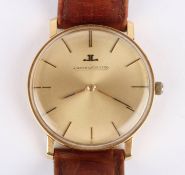A Jaeger le Coultre 18ct gold mechanical wrist watch the signed gilt dial with baton numerals and in