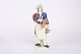 A 20th century Meissen porcelain figure of a laundry man holding a cauldron over his shoulder and