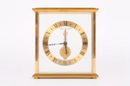 A Jaeger le Coultre inline desk clock with open gilded chapter ring and black Roman numerals, with