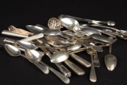 A collection of assorted silver cutlery including silver teaspoons, and silver handled butter