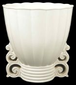 An unusual Art Deco Wade pottery vase a scalloped and fluted body with stylised scroll supports