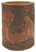 A 19th century Chinese carved bamboo brush pot carved with a scene of two seated figures playing Go,