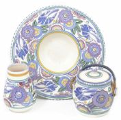 A small collection of 'Bluebird' Poole pattern comprising a small vase, biscuit barrel and charger