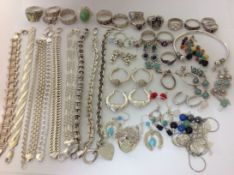 A collection of modern silver jewellery to include bracelets, rings and earrings, one of the rings