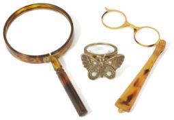A pair of faux tortoiseshell lorgnettes together with a horn magnifier, and a decorative hand held