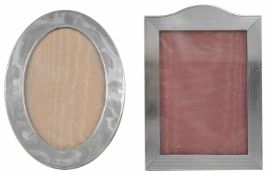 Two silver frames one of oval form, the other rectangular portrait, both with easel backs the