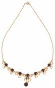 A contemporary 9ct gold garnet and pearl set drop necklace of seasonal stylised foliate scroll