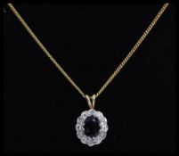 A ladies 9ct gold sapphire and diamond pendant and necklace chain.
