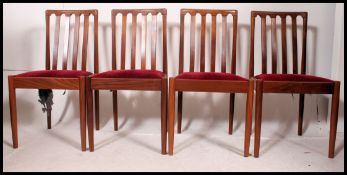 A set of 4 retro mid century Meredow dining chairs being raised on tapered supports with