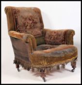 A Victorian tapestry upholstered chesterfield armchair in the manner of Howard & Sons.