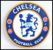 A Chelsea Football Club CFC painted circular wall plaque in metal.