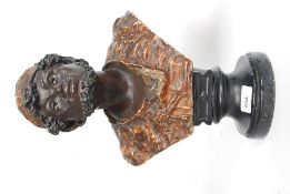 A late 19th / early 20th century  plaster bust study of a blackamoor being set on plaster ebonised