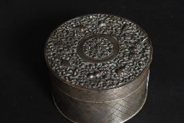 A 19th century Chinese silver trinket box of cylindrical form with chased decoration having an