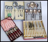 A collection of cased flatware dating from the mid 20th century to include knives,