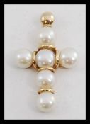 A 14ct gold and pearl set crucifix cross.